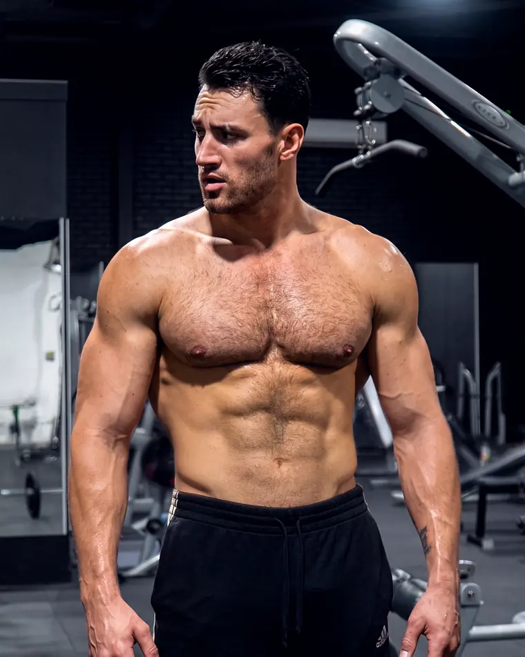 Matthew Heim resting between sets beside a cable machine